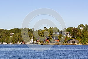 Traditional Norwegian house surrounded by trees and near the sea