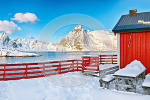 Traditional Norwegian red wooden houses on the shore of  Reinefjorden in Hamnoy villa