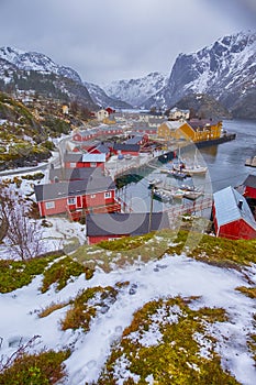 Traditional Norwegian Village in Nusfjord in Lofoten Islands in Norway. Against High Mountains