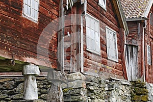 Traditional norwegian wooden red colored cabin houses facades. O