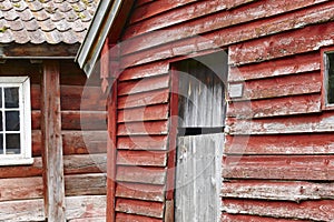 Traditional norwegian wooden red colored cabin houses facades. O