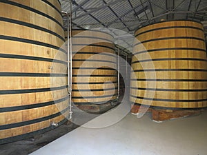 Traditional oak wood vats in rum distillery in Martinique, French West Indies. Large Oak Casks for the production of rum