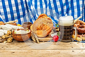 Traditional Oktoberfest set. Pretzels, beer, weisswurst, smoked pork knuckle eisbein with cabbage