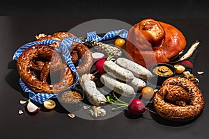 Traditional Oktoberfest set. Pretzels, smoked pork knuckle eisbein with hop