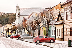 Traditional old buildings and parked cars in the street, Kezmarok, retro filter