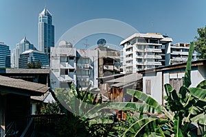 Traditional old houses and modern skyline in the background in Bangkok, Thailand