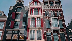 Traditional old narrow houses boats and canals in Amsterdam, Netherlands, Europe, January 20, 2024