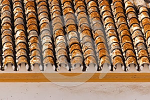 Traditional old Spanish ceramic roof tiles on a building, characteristic elements of Mediterranean architecture