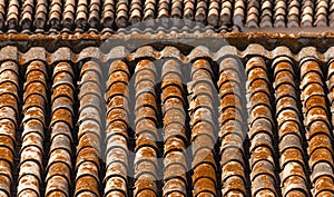 Traditional old Spanish ceramic roof tiles on a building, characteristic elements of Mediterranean architecture