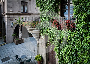 Traditional old Spanish street with beautiful balconies and arches in Barcelona town, Spain