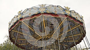 Traditional old style beautiful vintage carousel with wooden horses and fairytale carriage day time without people and