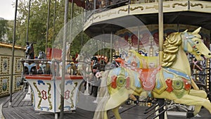 Traditional old style beautiful vintage carousel with wooden horses and fairytale carriage day time without people and
