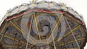 Traditional old style beautiful vintage carousel with wooden horses and fairytale carriage day time without people and