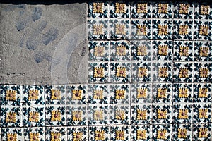 Traditional old tiles wall on street painted tin-glazed, azulejos ceramic tilework.