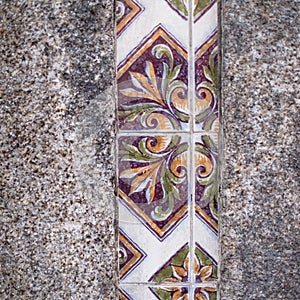 Traditional old tiles wall on the street Portuguese painted tin-glazed, azulejos ceramic tilework. photo