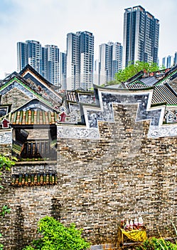 A traditional old village surrounded by modern architecture
