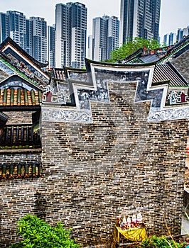 A traditional old village surrounded by modern architecture