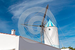 Traditional Old White Windmill against Blue Sky