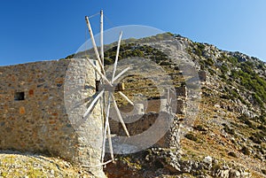 Traditional old windmill on island Crete, Greece. Beautiful landscape with blue sky