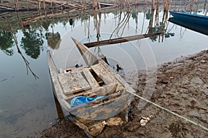 Traditional old wooden flooded boat in water