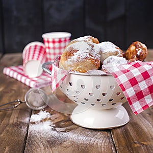 Traditional oliebollen, oil dumpling or fritter, with wooden spoon, for Dutch New Year`s Eve .Copy space