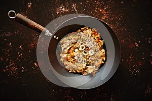 Traditional orginal fried spicy rice with chicken served in a round iron wok