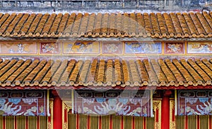 Traditional ornamental roofs with colorful tiles in a temple complex in the Citadel of Hue, Vietnam