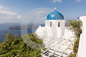 Traditional Orthodox blue dome church in Greece on a sunny summer day, with the typical blue and white colours. Santorini, Cyclade