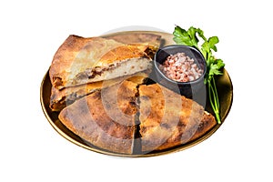 Traditional Ossetian pie sliced on a plate. Isolated on white background.