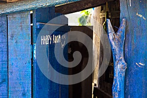 Traditional outdoor wooden toilet shed painted in blue commonly called happy room in rural Vietnam