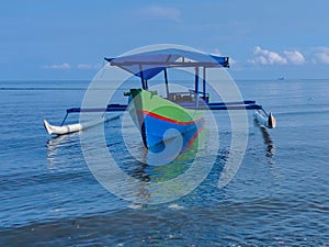 Traditional outrigger boat with a tranquil scene on Morowali beach