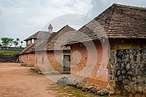 Traditional palace of the Fon of Bafut with brick and tile buildings and jungle environment, Cameroon, Africa