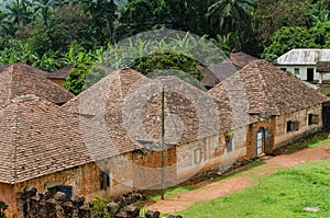 Traditional palace of the Fon of Bafut with brick and tile buildings and jungle environment, Cameroon, Africa photo