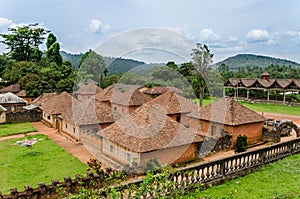Traditional palace of the Fon of Bafut with brick and tile buildings and jungle environment, Cameroon, Africa photo