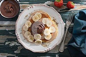 Traditional pancakes melted chocolate and banana
