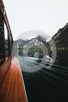 Traditional passenger boat gliding on Lake Konigssee with Watzmann mountain in the background