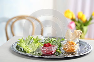 Traditional Passover Pesach Seder plate with symbolic meal on table indoors