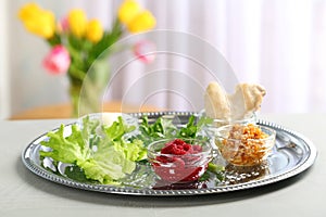 Traditional Passover Pesach Seder plate with symbolic meal on table, space for text photo