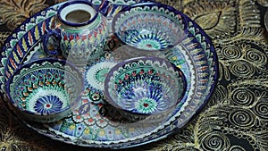 Traditional patterned dishes of Central Asia. A teapot and three tea cups