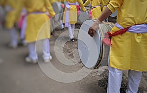 Traditional percussion instruments caled Dhol been played uring a Ganesh festival procession in India.