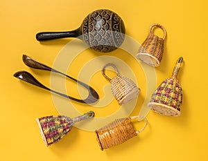 Traditional percussion instruments on yellow background