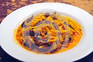 Peruvian Andean dish of Inca origin olluquito with charqui, alpaca dried meat and olluco tuber stew on plate photo