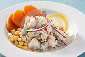 Traditional peruvian ceviche with fish, sweet potato, corn and vegetables