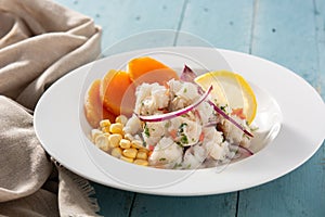 Traditional peruvian ceviche with fish, sweet potato, corn and vegetables