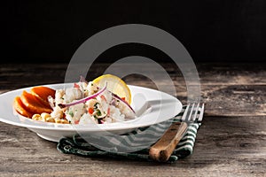 Traditional peruvian ceviche with fish, sweet potato, corn and vegetables