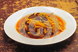 Peruvian food olluco tuber cooked with meat and sauce photo