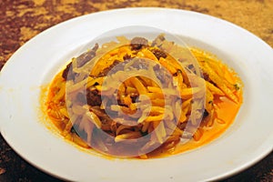 Peruvian food olluco tuber cooked with meat and sauce photo