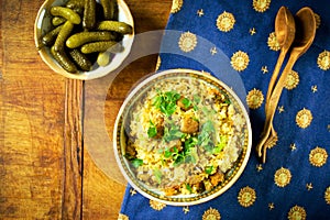 Traditional pilaf with meat and vegetables in a vintage bowl