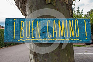 Traditional pilgrim`s sign on the Way of Saint James to Santiago de Compostela, Spain. Wooden vintage board `Buen Camino`. photo