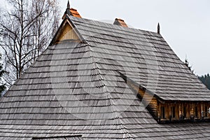 Traditional pine wood shingle roofing  on a log house